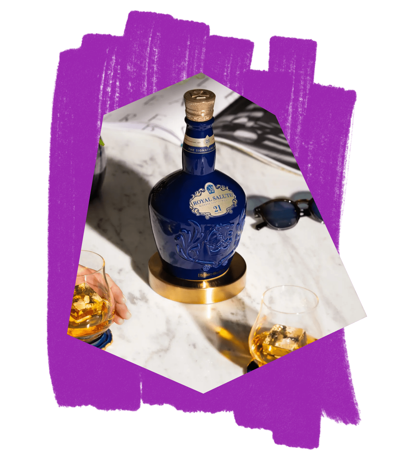 A bottle of Royal Salute and glasses on a marble tabletop, against a purple textured background.